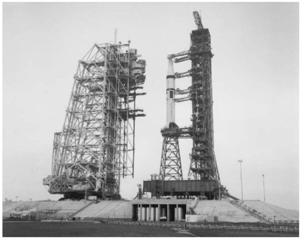 The Skylab vehicle on the ''milk stool'' on Pad 39B on 11 January 1971. The work stands on the Mobile Service Structure are clearly seen as it is propelled to the prelaunch position by the crawler. This figure is available in full color at http://www.mrw.interscience.wiley.com/esst.