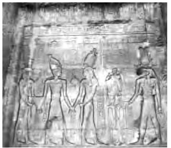 Renditions of the god Sobek and other deities attending the pharaoh shown in the center, as carved onto a temple wall. 