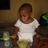  &ndash; Baby Roo feeding himself from baby food sent from Nazareth House Apostolate (James Mansaray, photographer)