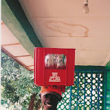  &ndash; James with case of empty soft drink bottles balanced on head. 2002 (Vicki Hicks, photographer)