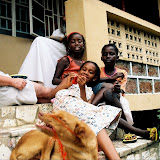  &ndash; On the porch playing with dog, Simba (James B. Mansaray, photographer)