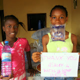  &ndash; Ann Marie and Lucy with water supplies and thank you note. (James Mansaray, photographer)