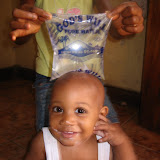  &ndash; Roo with Lucy holding water over his head. (James Mansaray, photographer)