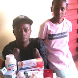  &ndash; Tamba Gaugah with Lucy Mansaray and the supplies he received. (Photo property of NHA, James Mansaray, June 2007)