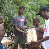  &ndash; James sharing bread with his neighbors along the way to Kabala. © 2007NHA photographs/JBM