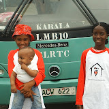  &ndash; 19 August, 2007: Ann Marie and Lucy holding Roo, standing in front of the newer buses to travel to Kabala. James travels my cheaper, more "modest" methods but brought his family by bus to Kabala. It broke down several times. ...© 2007 NHA photos, J Mansaray