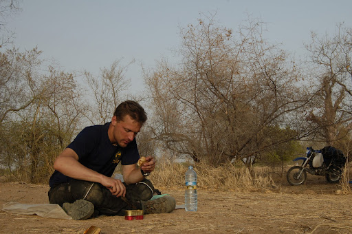 Dinner in the Malian bush: Old baguette and sardines, just perfect after a long day's ride.