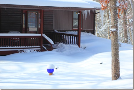 House with snow up to the porch