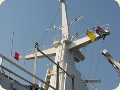 Red & white flag on left say Pilot on board, yellow flag invites customs on  board for clearance, and the far right is the county (RSA) flag 