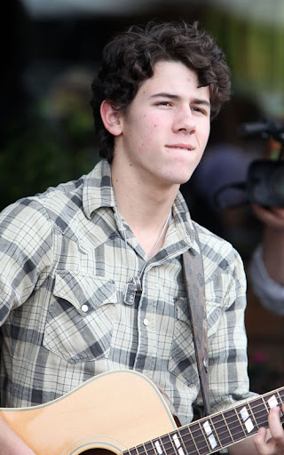 02-02-10 Sherman Oaks, CA  Nick Jonas performed a solo show for his fans outside of Mark's Garden flower shop in Sherman Oaks. After the show, he handed out roses to all the girls in attendance. Like a typical teenager, Nick has a few zits on his face.  NON-EXCLUSIVE PIX by Flynet ©2010 818-307-4813  Nicolas