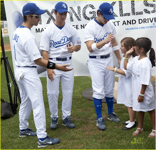 NEW BRITAIN, CT - AUGUST 13: (L-R) Jonas Brothers Joe Jonas (1), Kevin Jonas (19), and Nick Jonas (2), pose with fans during a Road Dogs baseball game to support Allstate's X the TXT at the New Britain Stadium on August 13, 2010 in New Britain, Connecticut. (Photo by Wendy Carlson/Getty Images)