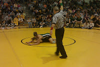 Pella's A.J. Arrendell scores a takedown on his opponet during Saturday's District meet in Knoxville.  Arrendell would later qualify for the state meet.