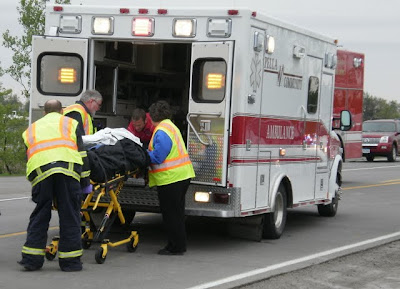 Pella EMTs load the driver of the second vehicle into an ambulance