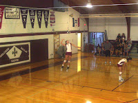 PCM's Erica Neideigh attempts a jump serve.