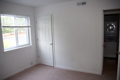 Second bedroom with view into utility closet across the hallway