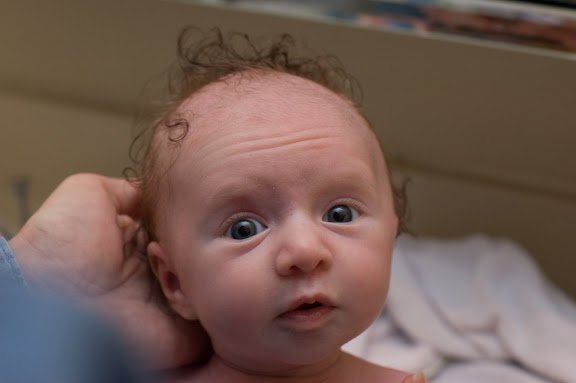 Sam with wild and crazy hair, after a huge diaper blowout, affecting regions as disperse as elbows and feet.