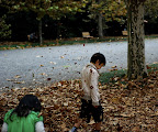 Leaves fly around boy in Shinjuku Gyoen