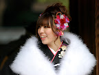 Many girls wore some kind of floral adornment in the hair. Oh, and that's a real fur shawl.
