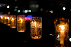The candles were floating in water so if they were blown over, the water would douse the flame.