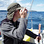 Eric taking photos and steering Whisper through Port Madison
