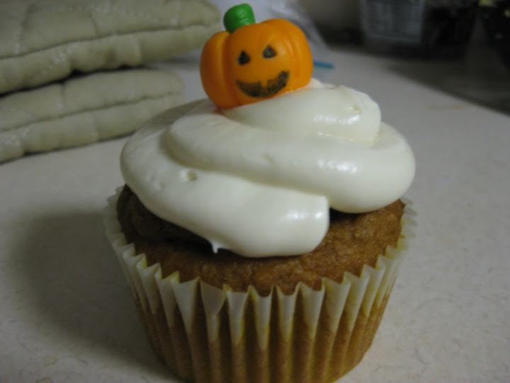 Pumpkin cupcake with a jack-o'-lantern on top