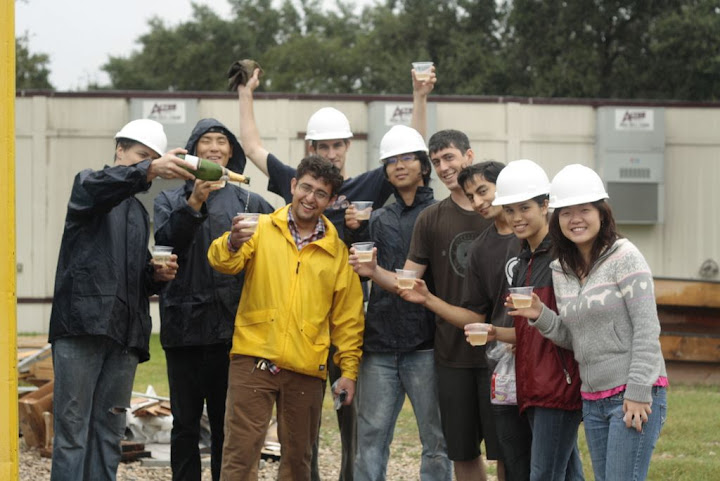 Team members, a little damp from morning showers, celebrate a successful first lift!