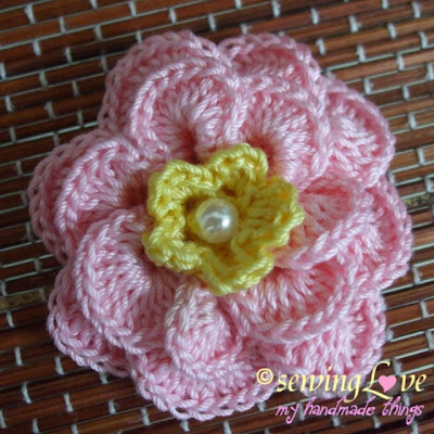 "Top view of crochet flower pin."