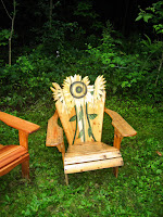 A painted Adirondack behind the Carriage House @ the Meadowlark Inn