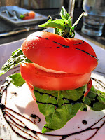 A Tomato with Mozzarella, Basil, and a balsamic glaze
