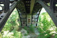 Date: June 2008
Location: Toronto

Who knew there was a ravine there. Well traveled as it turns out. I found it while trying to save some money on parking expenses. This part of the ravine is well groomed and looked after. Which makes the presence of graffiti even more surprising. There is lots of graffiti under and around the bridge. This is just one example.