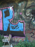 Location: Barcelona, 2006

This picture, as promised, was taken under the overpass. I liked the colours and the lonely chair. Who would come and sit there? What would they be contemplating? So many questions.