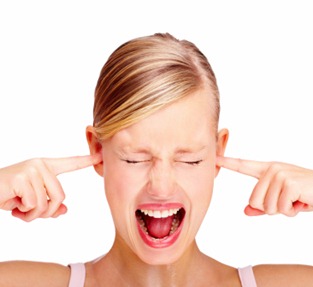 Portrait of disturbed young female screaming while putting finger in her hears Portrait of disturbed young female screaming while putting finger in her hears