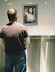 Inspiration in men's room - Beautiful lady is trying hard to make men's room visitors feel better.