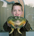Huge frog - That boy looks truly excited.