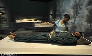 A visitor looks at the 18th century Hungarian mummy of Michael Orlovits A visitor looks at the 18th century Hungarian mummy of Michael Orlovits