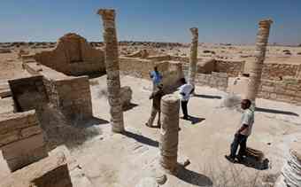 Egyptian antiquities experts walk at the partially restored villa at the ancient city of Leukaspis.