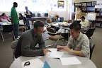 Volunteer Matt Cusick and Jonathon Angulo look over Jonathon's expenses