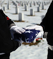 180px-A-Funeral-Flag%2C-American-Veteran-Soldier%2C-The-Red%2C-White%2C-and-Blue%2C-Stars-and-Stripes%2C-Patriotic%2C-Memorial-Day-2009%2C-Cemetery-6337-2010-05-28-08-35.jpg