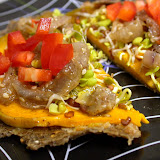 Raw bread with a marinated/dehydrated squash pattie and onions, red bell peppers and radish sprouts. You have to taste to believe the goodness in here.