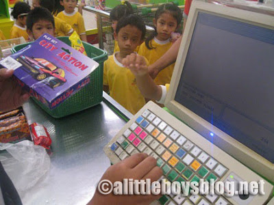 Kids go shopping Kids lining-up at the check-out counter