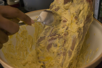 Scraping some of the marinade from the Arabic Roast Lamb