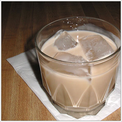 Fill a glass with ice, add Kahlua, milk and 