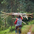 Woman carrying pole on her head along road Woman carrying pole on her head along road