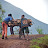 Youth pushing a bike with logs up a muddy road near volcano Youth pushing a bike with logs up a muddy road near volcano
