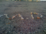 Michael writes his initials in rocks