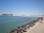 To the south is sandy beach with a rocky coast interspersed. There are resorts and hotels scattered along the coast.