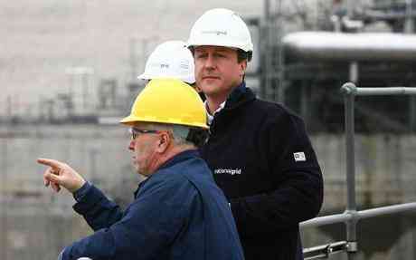 Conservative Party Leader David Cameron (centre) is shown around the National Grid Grain LNG site in Grain, Kent, by Director of National Grid LNG, Peter Boreham, as the Conservative Party launch their Energy Security Green Paper.