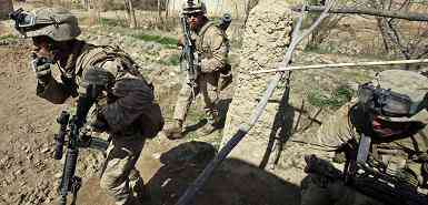 U.S. Marines from Bravo Company of the 1st Battalion, 6th Marines move towards Taliban positions during a conflict in Marjah in Helmand province, southern Afghanistan