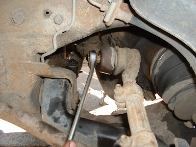 With the idler arm done, I moved to removing the tie rods on the passenger side.  The idler and pitman arms hold the center link to the frame/steering box.  The tie rods attack the center link to the spindle, which is what the wheels are actually mounted to and the part that actually turns your car.  Removing these was much the same as the idler arm.  You remove a cotter pin on the nut, remove the nut, and hammer them out with a pickle for.  Fortunately these were much less stubborn!