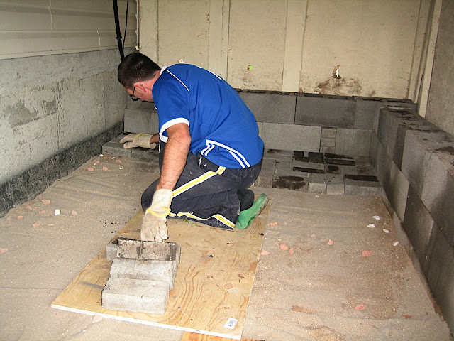 Jeff under the deck laying bricks